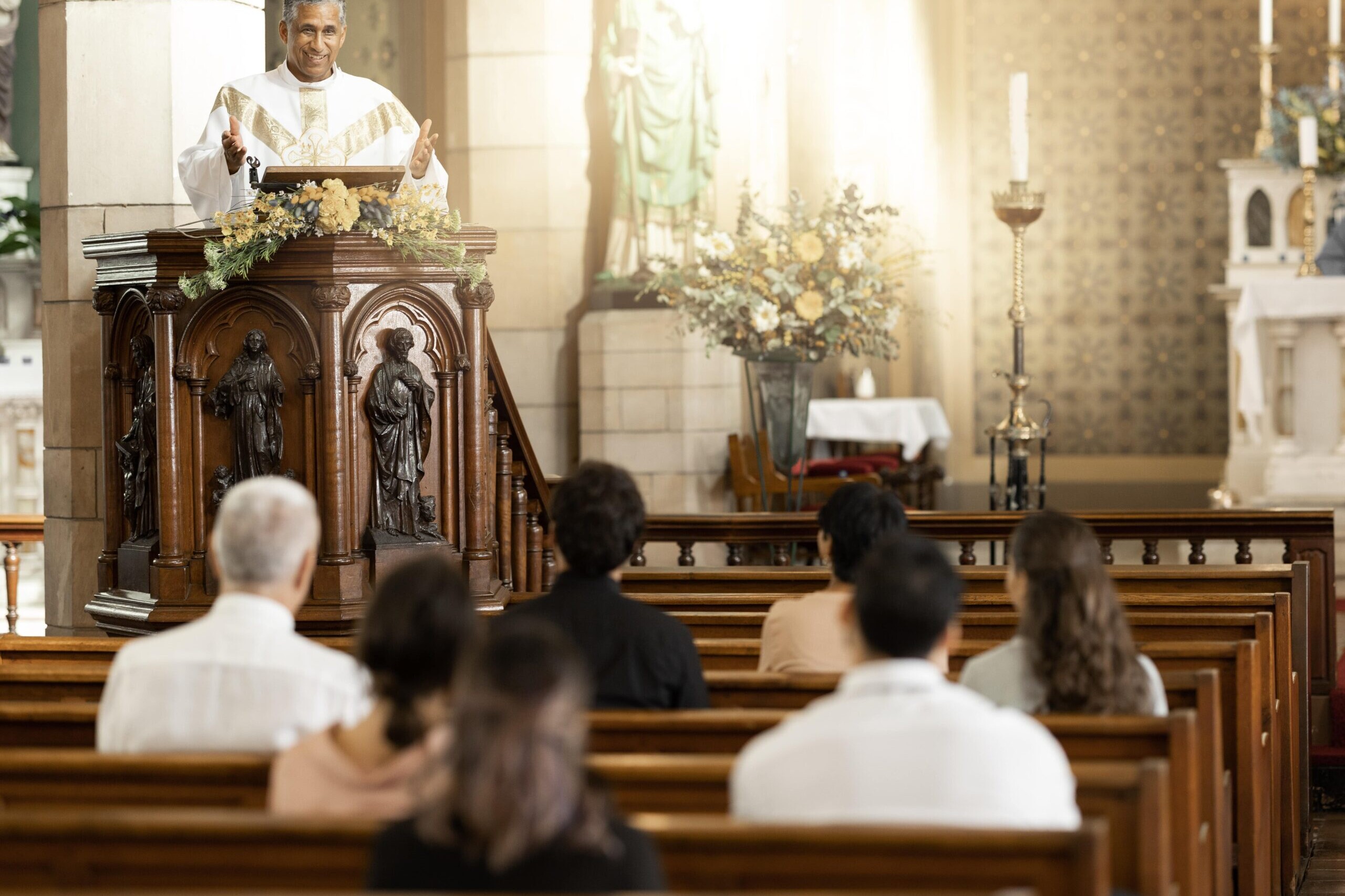 Priest delivering a sermon in church during a service with congregation, illustrating concept of faith streaming and online worship
